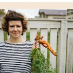 Female Farmer Harvesting Carrots In Garden